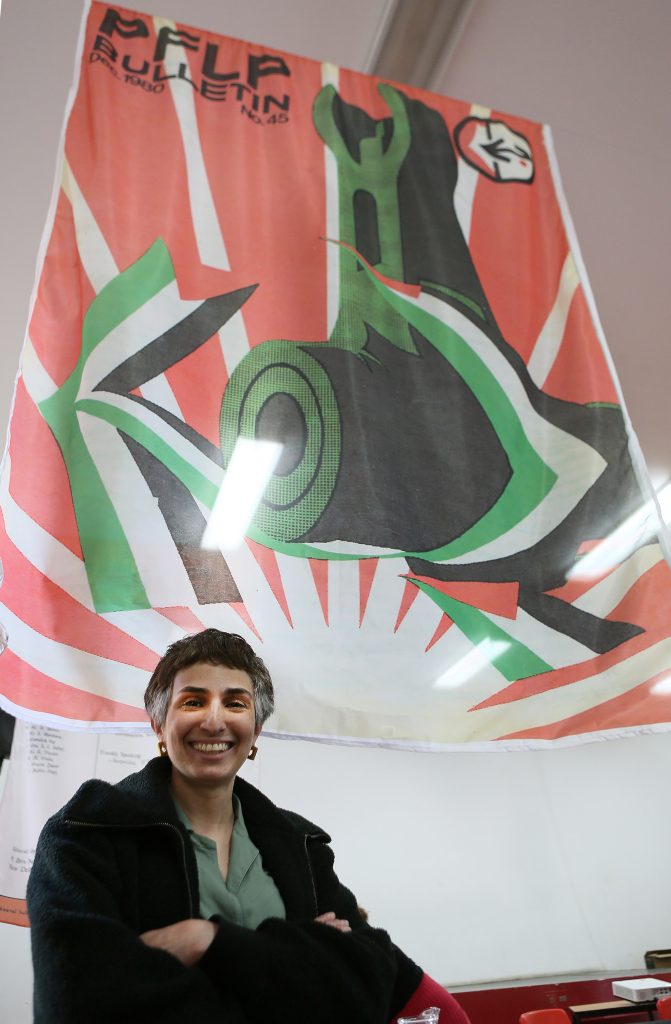 Photo of Danah Abdulla with PFLP Bulletin front cover.
