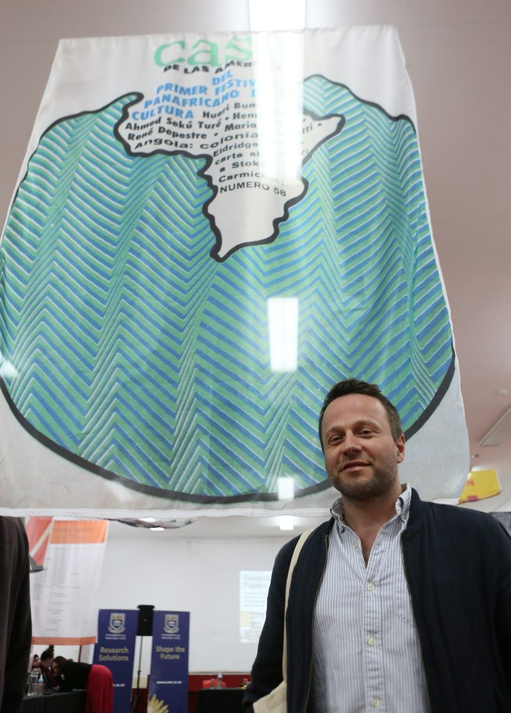 Photo of Przemyslaw Strozek with cover art from Casa De Las Americas. 